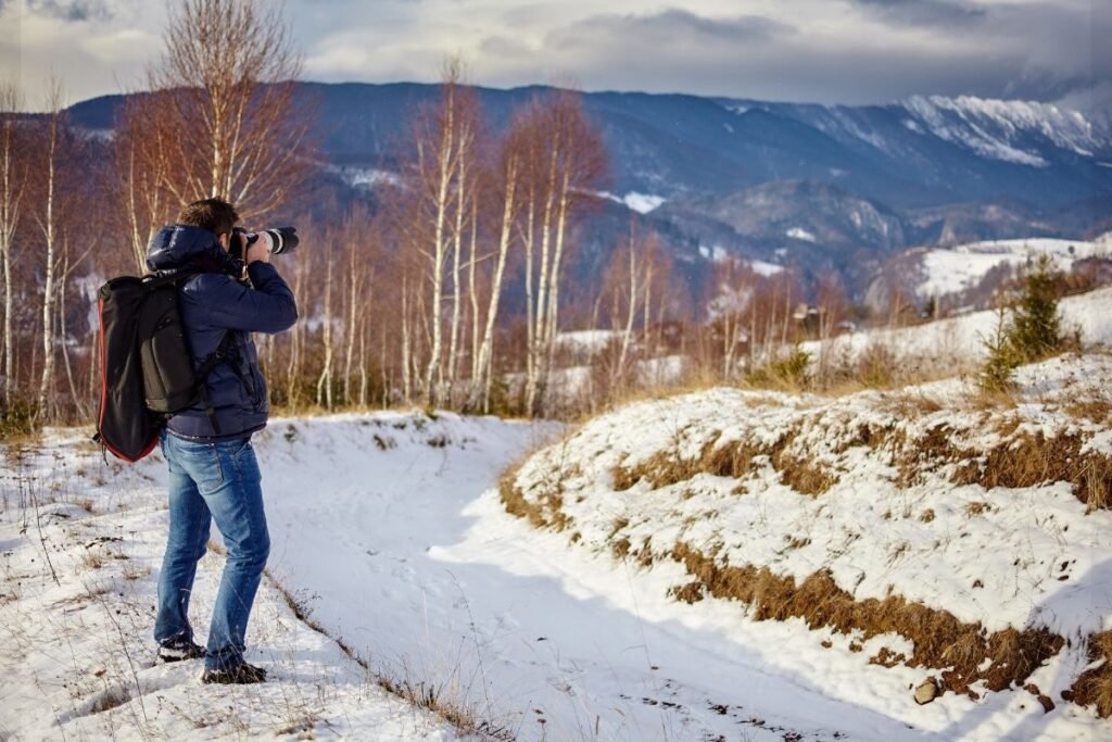 Content creator photographing a winter landscape